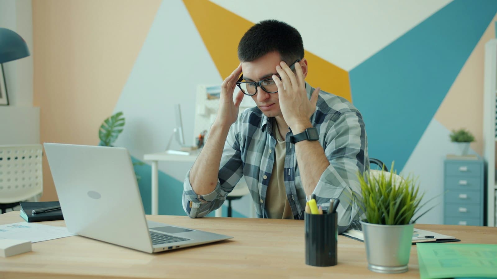 A focused professional working through a difficult problem at their desk